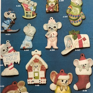 May include: A collection of 12 ceramic mouse ornaments for Christmas. The ornaments feature various designs, including a mouse in a rocking chair, a mouse wearing a stocking cap, a mouse holding a sign that says "North Pole", and a mouse in a house. The ornaments are all white with painted details in red, green, blue, and pink.