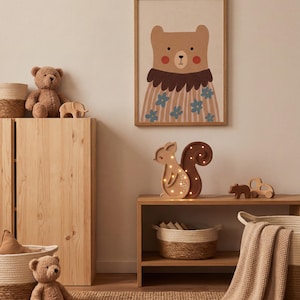May include: A cozy nursery scene featuring a framed bear illustration, a light-up squirrel, and a teddy bear. Woven baskets, wooden toys, and a soft blanket add to the warm, inviting atmosphere. The room is decorated in neutral tones.