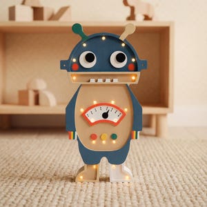 May include: A wooden robot-shaped night light with a navy blue head, tan body, and light-up features. The robot has large eyes, antennae, and a gauge on its chest. The light has a retro design and is suitable for a child's room.