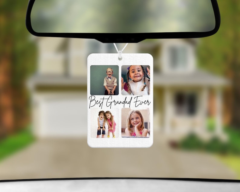 May include: A white rectangular car air freshener with four photo inserts and the text "Best Grandad Ever" in black script. The photos show children. The air freshener hangs from a car's rearview mirror.