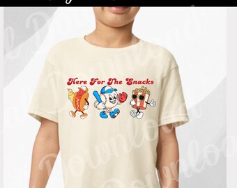 May include: A cream colored t-shirt with a graphic of a baseball, hot dog, and popcorn bucket. The text "Here For The Snacks" is above the graphic.