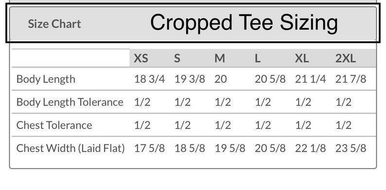 May include: Cropped tee sizing chart with measurements in inches for XS, S, M, L, XL, and 2XL sizes. Measurements include body length, body length tolerance, chest tolerance, and chest width laid flat.