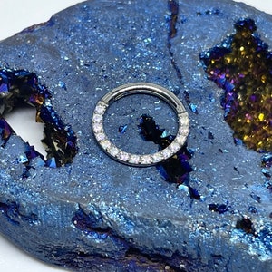 16 gauge 5/16 titanium hinged clicker with a row of 1.5mm AB/CZ gem Hindge ring. Septum Daith
