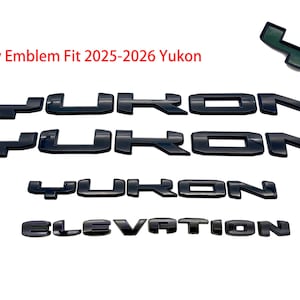 May include: Black overlay emblem set for a Yukon vehicle. The set includes the word "YUKON" in multiple arrangements and the word "ELEVATION". The text "Overlay Emblem Fit 2025-2026 Yukon" is also visible.