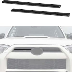 May include: A black plastic grille insert for a white SUV. The grille insert has two horizontal black bars.