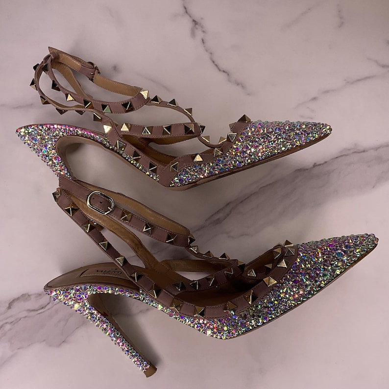 Crystal-finished Valentino Rockstud heels in blush nude with AB sparkle – angled view.