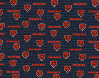 May include: A navy blue fabric with a repeating pattern of red bear heads and the word "BEARS" in white.