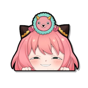 May include: A sticker featuring a cartoon character with pink hair and a smiling expression. The character has cat-like ears and a small creature on their head. The sticker has a white border and a shadow.