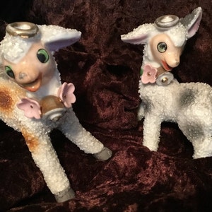 Vintage Japanese sugar glaze anthropomorphic lamb figurines with green eyes, gold halos and flower collars, ceramic mid century sheep