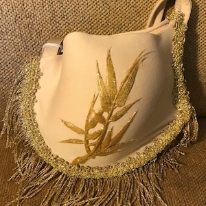 Gold Tata Tote, Ribbon and Fringe accents, Eye and Hook clasp