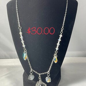 Mighty handmade dragon claw necklace with teardrop shaped Swarovski crystal beads and Swarovski crystal bicones