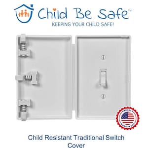 May include: White plastic childproof switch cover with a traditional light switch design. The cover has a hinged lid that opens to reveal the switch. The cover is made in the USA.