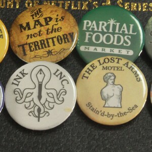 Buttons inspired by the All The Wrong Questions books