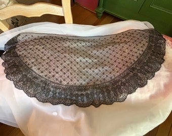 Half moon shaped black lace table runner