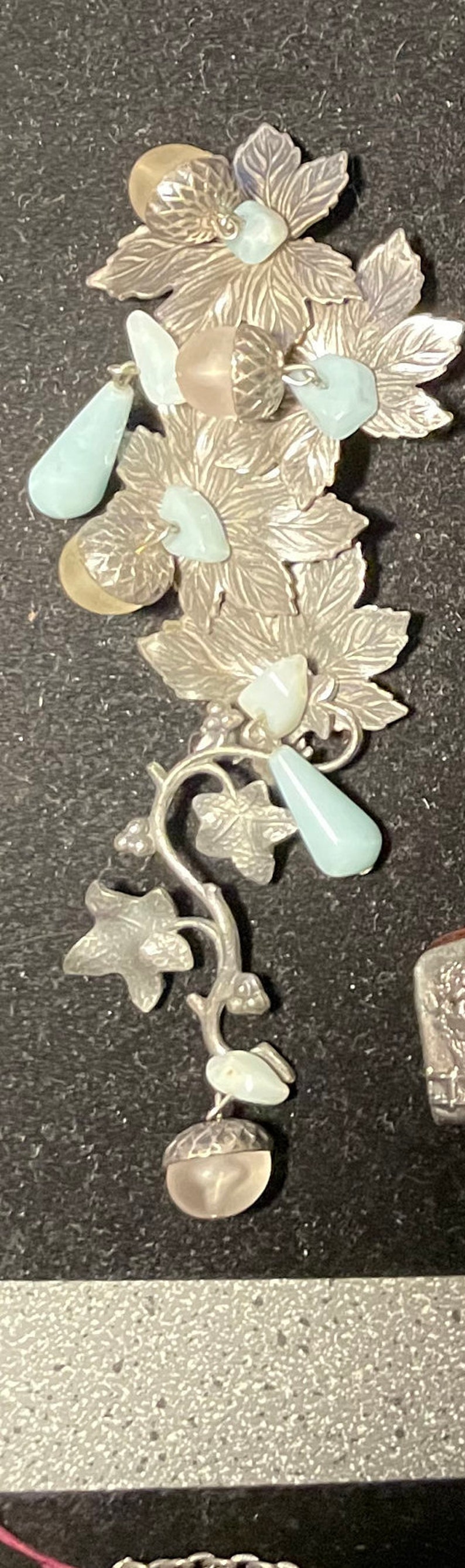 Silver pin with branches and leaves