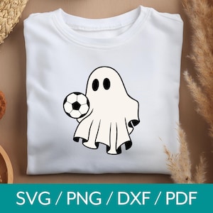 May include: A white ghost wearing a white sheet with two black eyes holding a black and white soccer ball.