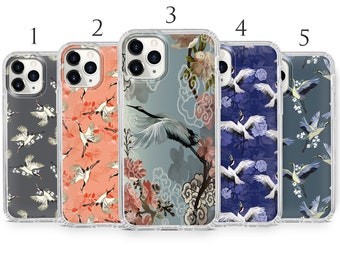 Peut inclure: Cinq étuis de téléphone différents avec un motif de grue et de fleurs. Les étuis sont transparents et laissent apparaître le motif à travers l'étui. Les motifs sont dans des tons de bleu, gris et rose.
