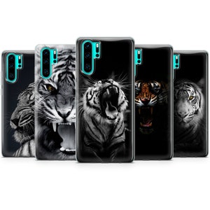 May include: Set of five phone cases featuring different images of tigers. The cases are black with a clear back and show a white tiger with its mouth open, a white tiger with its mouth closed, a white tiger with its mouth closed, a brown and orange tiger with its mouth open, and a white tiger with its mouth closed.