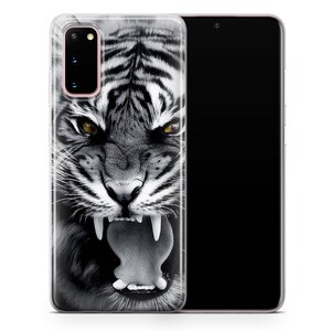 May include: A clear phone case with a black and white image of a tiger's face. The tiger is roaring with its mouth open and its teeth showing. The phone case is designed for a Samsung Galaxy S20.