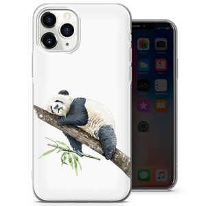 May include: A white phone case featuring a watercolor illustration of a panda bear resting on a tree branch, with bamboo leaves. The panda has black and white fur. The phone case is next to a smartphone.