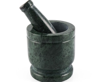 May include: A green marble mortar and pestle. The mortar is round and has a wide base. The pestle is long and has a rounded end.