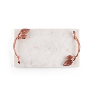 May include: White marble serving tray with copper leaf-shaped handles.