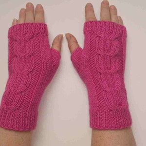 May include: A pair of pink fingerless gloves with a cable knit pattern.