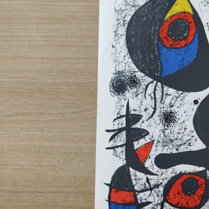 May include: Abstract art print featuring black, white, red, blue, and yellow shapes on a white background. The print has a textured, hand-painted look.