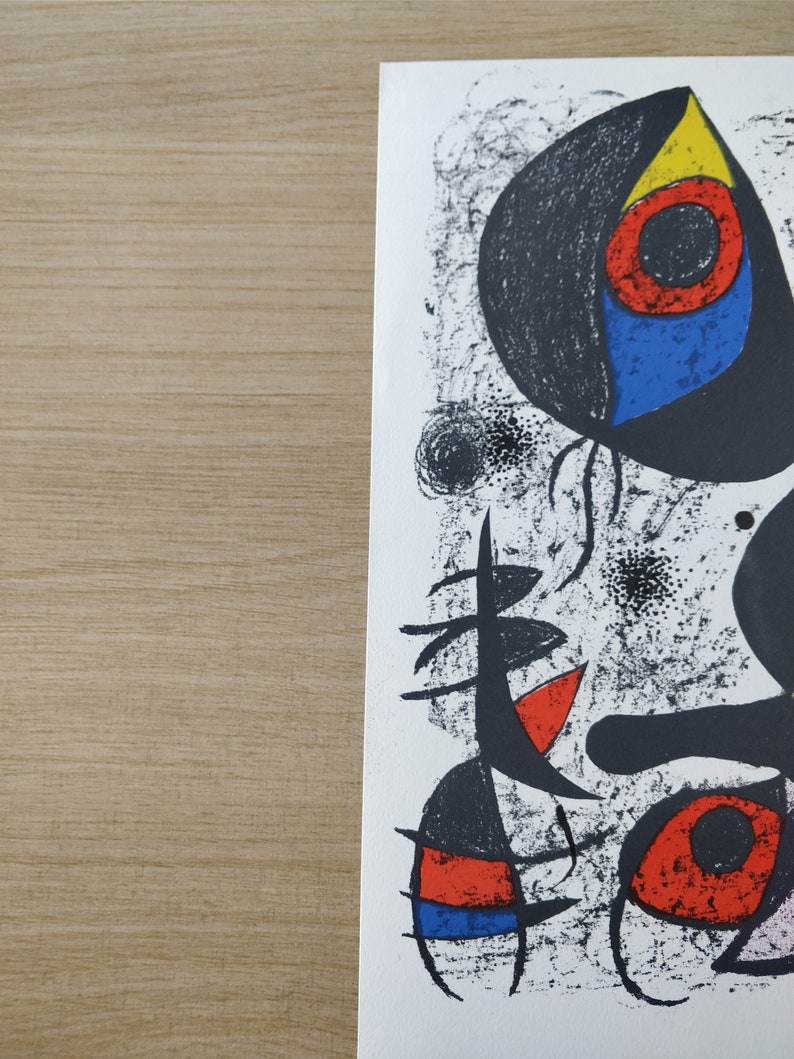 May include: Abstract art print featuring black, white, red, blue, and yellow shapes on a white background. The print has a textured, hand-painted look.