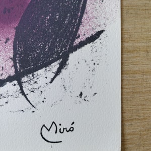 May include: A black and white abstract painting with a pink background. The painting is signed "Mir&oacute;" in the lower right corner.