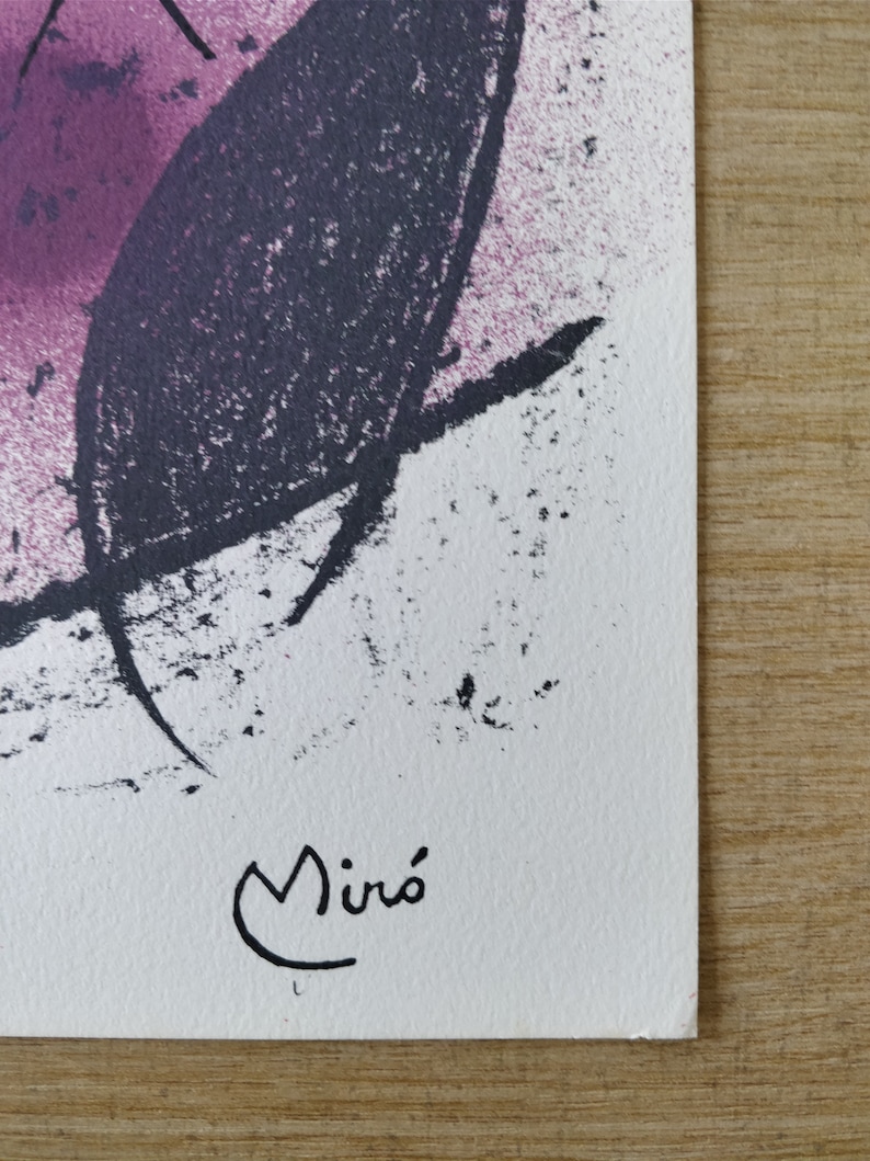 May include: A black and white abstract painting with a pink background. The painting is signed "Mir&oacute;" in the lower right corner.