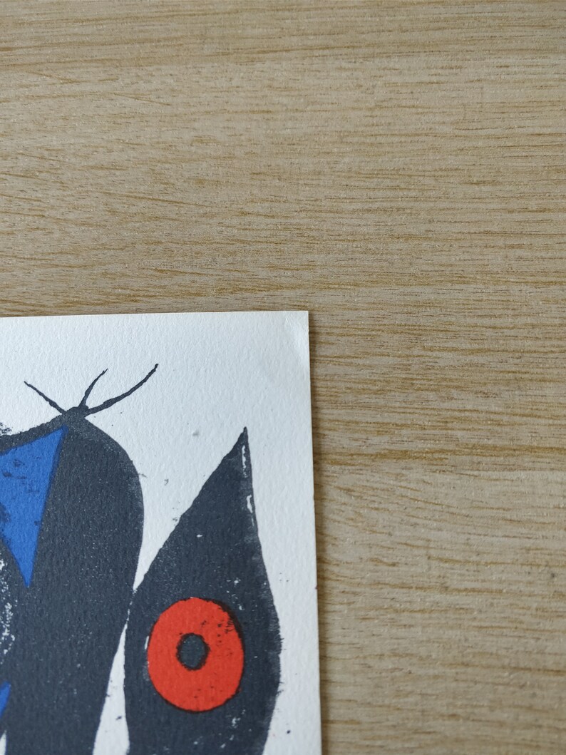 May include: A black and white abstract art print with a blue triangle and a red circle. The print is on a white background.