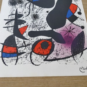 May include: Abstract art print featuring black, red, blue, and purple shapes on a white background. The print is signed "Mir&oacute;" in the bottom right corner.
