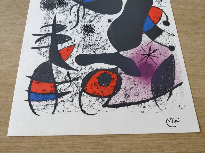 May include: Abstract art print featuring black, red, blue, and purple shapes on a white background. The print is signed "Mir&oacute;" in the bottom right corner.