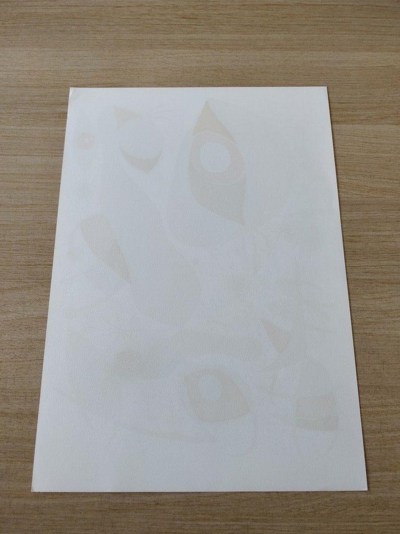 May include: A white sheet of paper with several faint, light brown, abstract shapes printed on it.