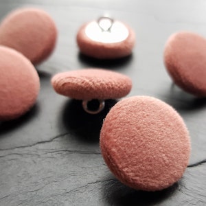 May include: Six dusty rose coloured velvet buttons with silver metal shanks.