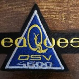 May include: A blue and yellow embroidered patch with a triangle design and the text "Seaquest DSV 4600".