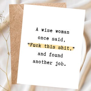 May include: A white greeting card with black typewriter-style text that reads, A wise woman once said, Fuck this shit, and found another job. The phrase Fuck this shit is highlighted with a yellow marker-style bar. A brown envelope is behind it.