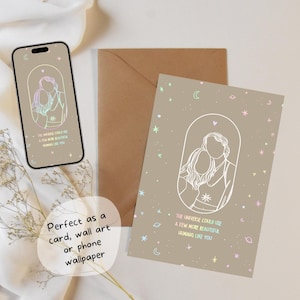 May include: A light brown card with a white outline of a couple standing together. The card has a rainbow gradient of stars, moons, and planets. The text on the card reads "The universe could use a few more beautiful humans like you!"