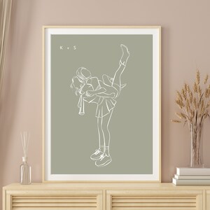 May include: A line drawing of two people in a playful pose, one holding the other in the air. The drawing is in white on a sage green background. The initials "K + S" are in the top left corner.