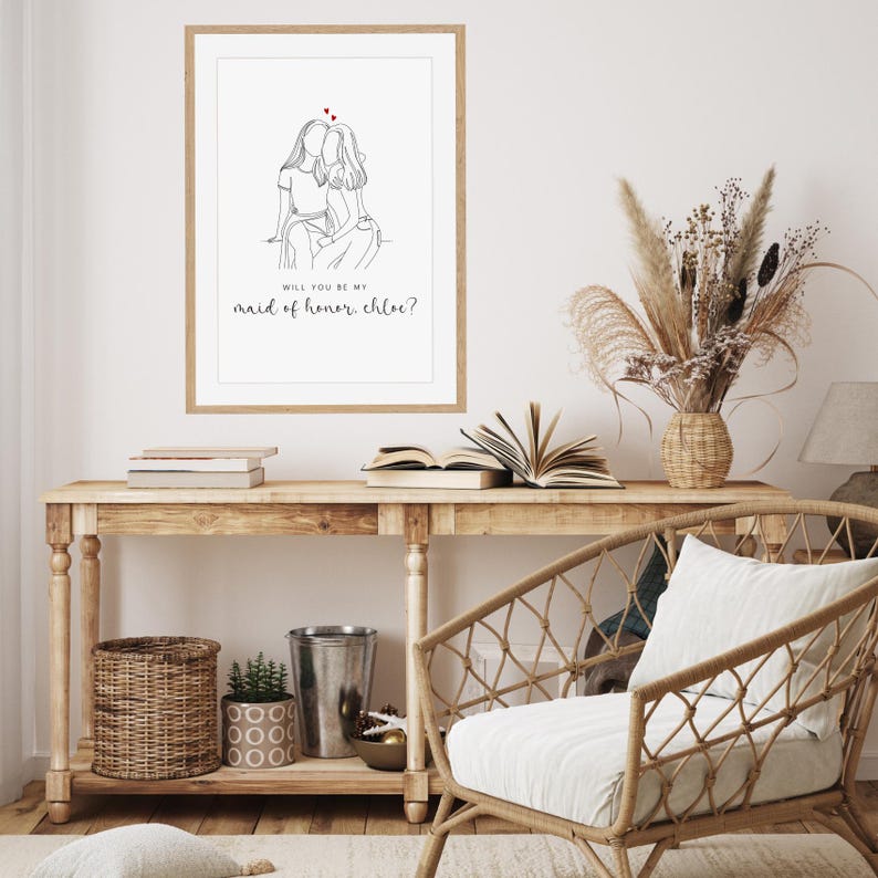 May include: A printable card with a line drawing of two women hugging. The text reads "Will you be my maid of honor, Chloe?"