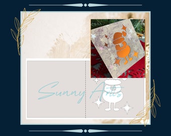 May include: A square card featuring a metallic orange silhouette of a Santa Claus figure surrounded by various star shapes. The card has a textured, light-colored background. The text Sunny Arts is printed in light blue script across the lower section.