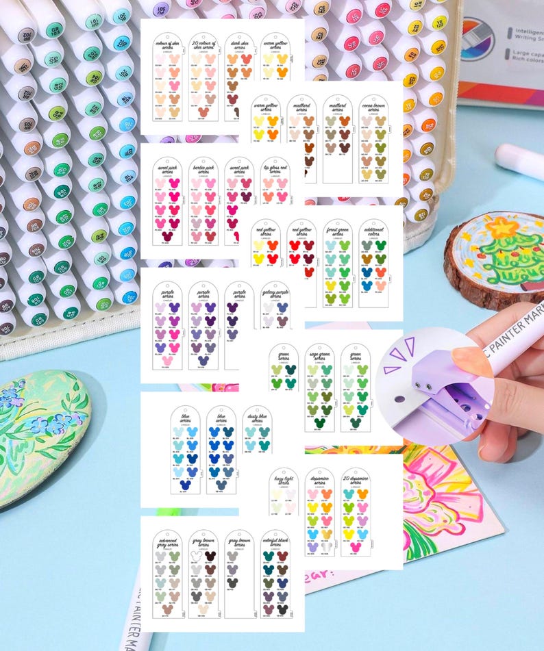 May include: A collection of colorful art markers with a clear plastic case. Color swatches are displayed on small cards, showcasing a wide range of hues, including skin tones, pinks, reds, greens, blues, and browns. A hand holds a marker, demonstrating its use.