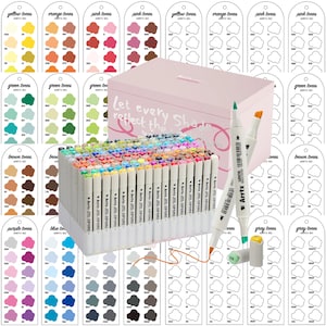 May include: A set of Arrtx dual-tip art markers in a pink box, with color swatches. The markers are arranged in a clear plastic holder. Two markers are shown with their tips exposed, one green and one orange.