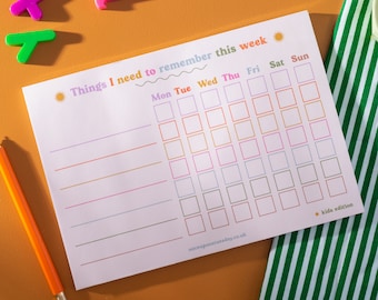 May include: A printable weekly planner with a colorful design. The planner has a title that says "Things I need to remember this week." The planner has a grid with days of the week labeled at the top: Monday, Tuesday, Wednesday, Thursday, Friday, Saturday, and Sunday. The planner has a note at the bottom that says "kids edition".