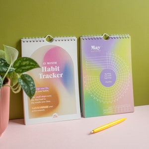 May include: A 12-month habit tracker with a colourful gradient cover. The cover features the text "12 Month Habit Tracker" and the quote "Big things have small beginnings -  Prometheus".