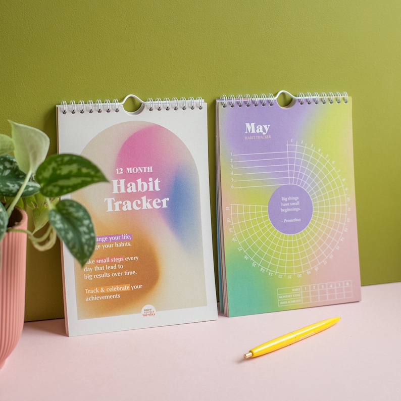 May include: A 12-month habit tracker with a colourful gradient cover. The cover features the text "12 Month Habit Tracker" and the quote "Big things have small beginnings -  Prometheus".
