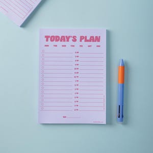 Lilac and Plum Notepad with 'Today's Plan' schedule and a pen on a light blue background