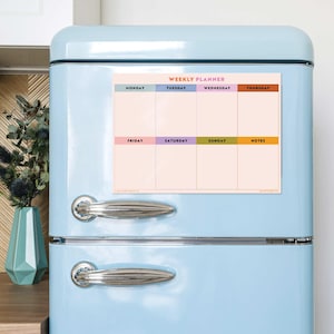 May include: A weekly planner magnet with a pastel pink background and colourful headers for each day of the week. The days of the week are Monday, Tuesday, Wednesday, Thursday, Friday, Saturday, Sunday, and Notes.