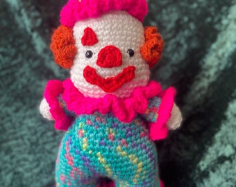 Bright colourful handmade crochet clown plushie